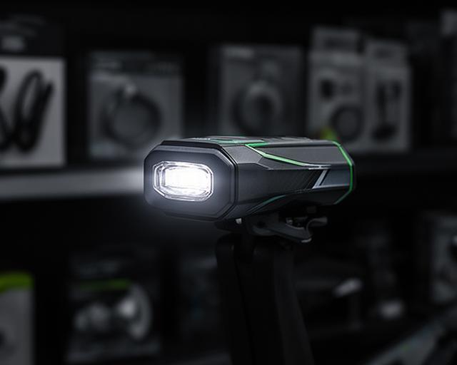 Luz traseira USB de bicicleta ligada num suporte de loja escuro